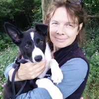 Vimalacitta holding black & white dog
